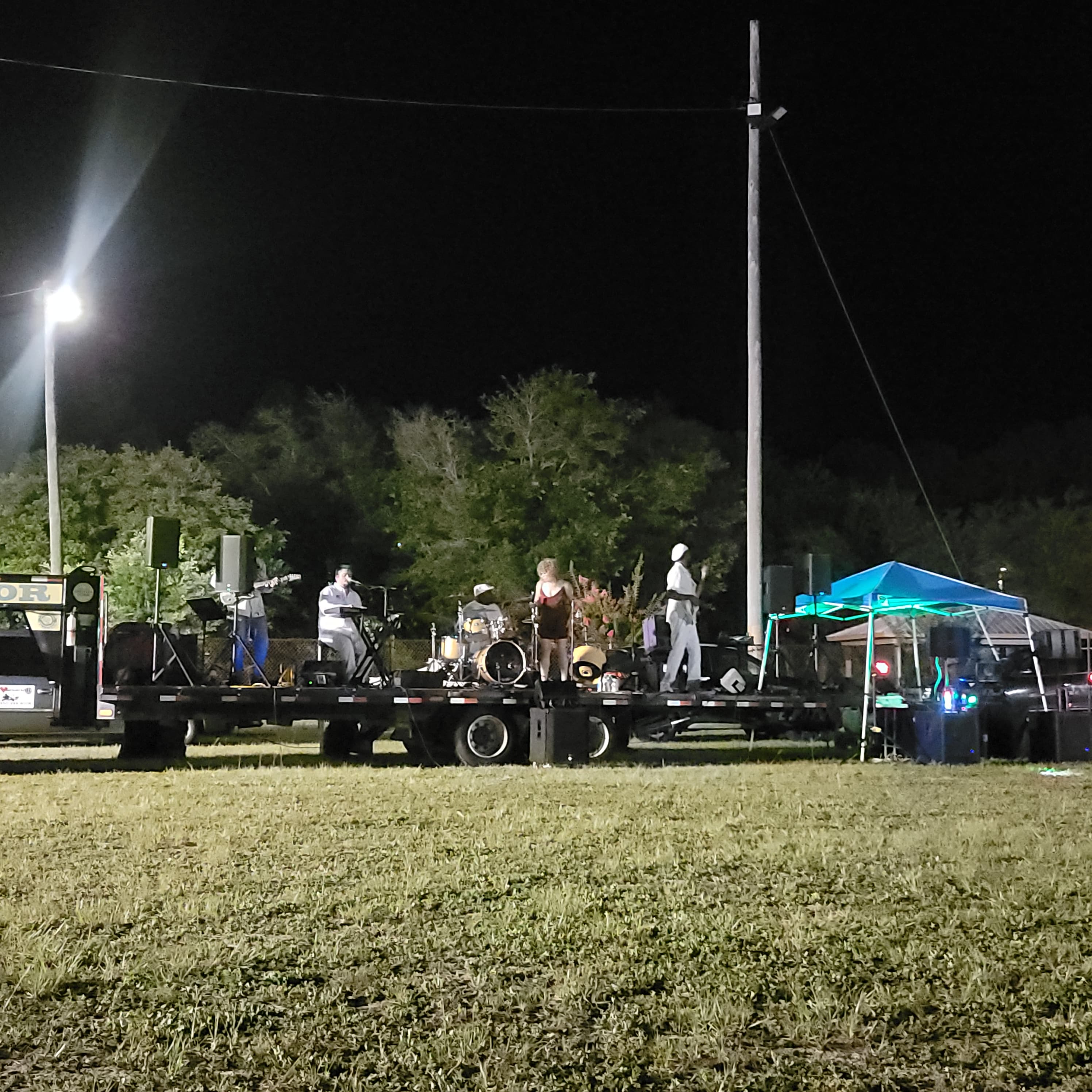 Live band performing on a flatbed stage at the Juneteenth evening concert