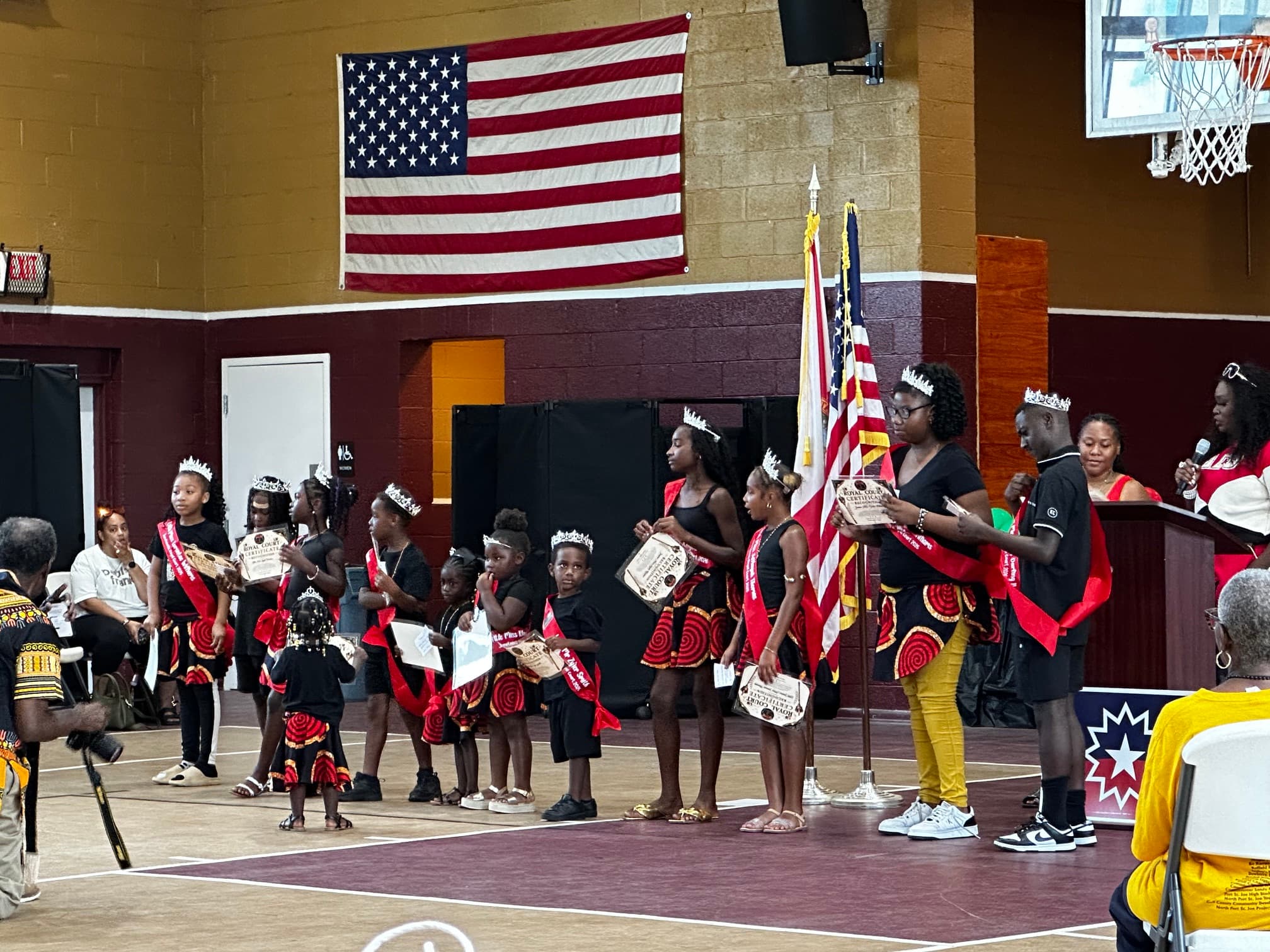 Young girls in matching outfits receiving recognition at the Juneteenth ceremony at Washington High School